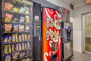 A vending machine with snacks and a Coca-Cola branded machine. - 2 Full Beds | Non-Smoking, Kitchen (Groves)