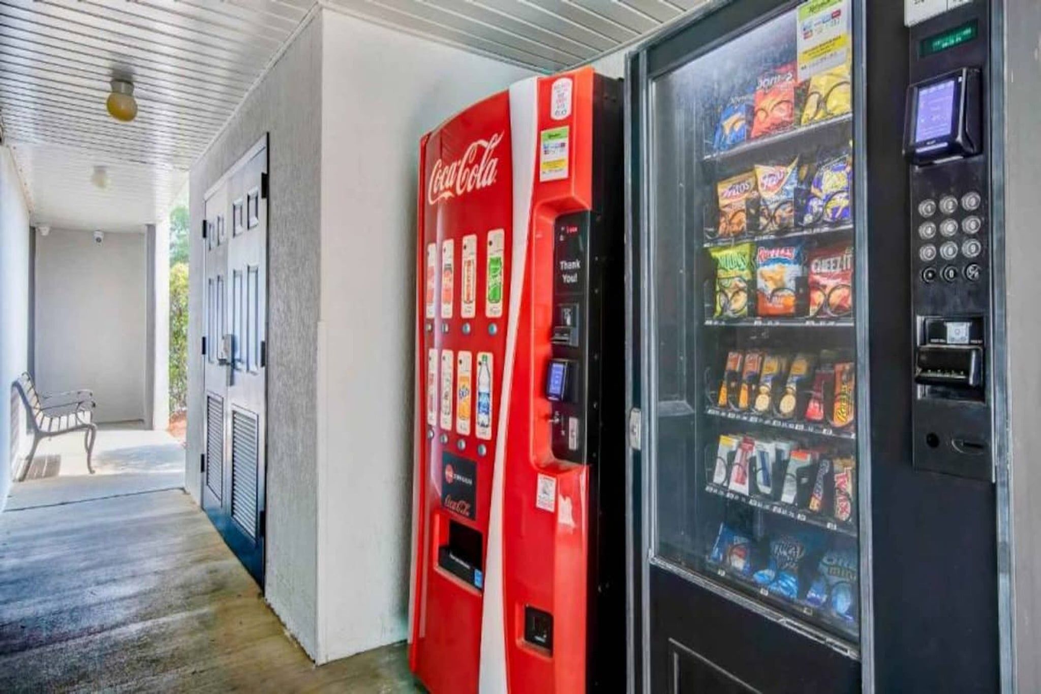 Ein Automatenbereich mit einer Coca-Cola-Maschine und einem Getränkeautomaten.