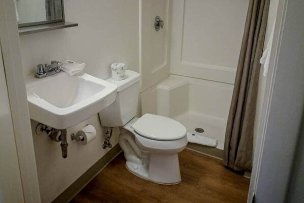 A bathroom with a sink, toilet, and bathtub.