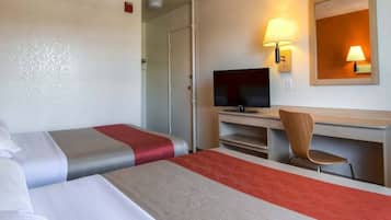 A hotel room with two beds, a television, a desk with a chair, and two wall-mounted lamps.