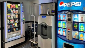A vending machine area with a Pepsi dispenser and a variety of snacks. - 1 King Bed | Non-Smoking, Kitchen (Clarion)