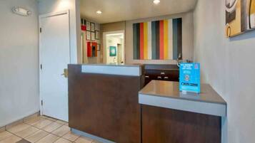 A reception area with a counter, a door, and a wall with a vertical stripe pattern.