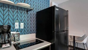 A kitchenette with a black refrigerator, a coffee maker, and a microwave. - 1 King Bed|Non-Smoking,Kitchen (Jacksonville)