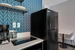 A kitchenette with a black refrigerator, a coffee maker, and a microwave. - 1 King Bed|Non-Smoking,Kitchen (Jacksonville)