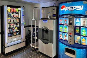 A vending machine area with a Pepsi dispenser and a variety of snacks.