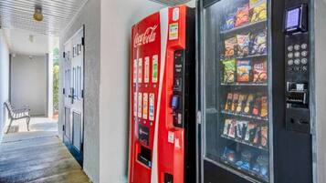 A vending machine area with a Coca-Cola machine and a beverage dispenser.