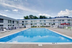 A swimming pool with a clear blue water surface, surrounded by a white fence. - 1 Queen Bed|Non-Smoking, Micfridge (Clarion)