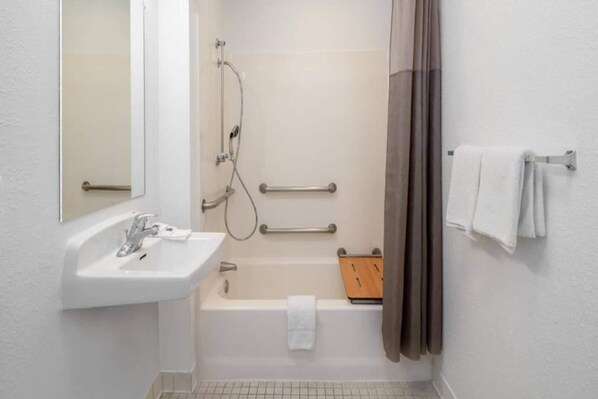 A bathroom with a sink, a shower, a bathtub, and a toilet.