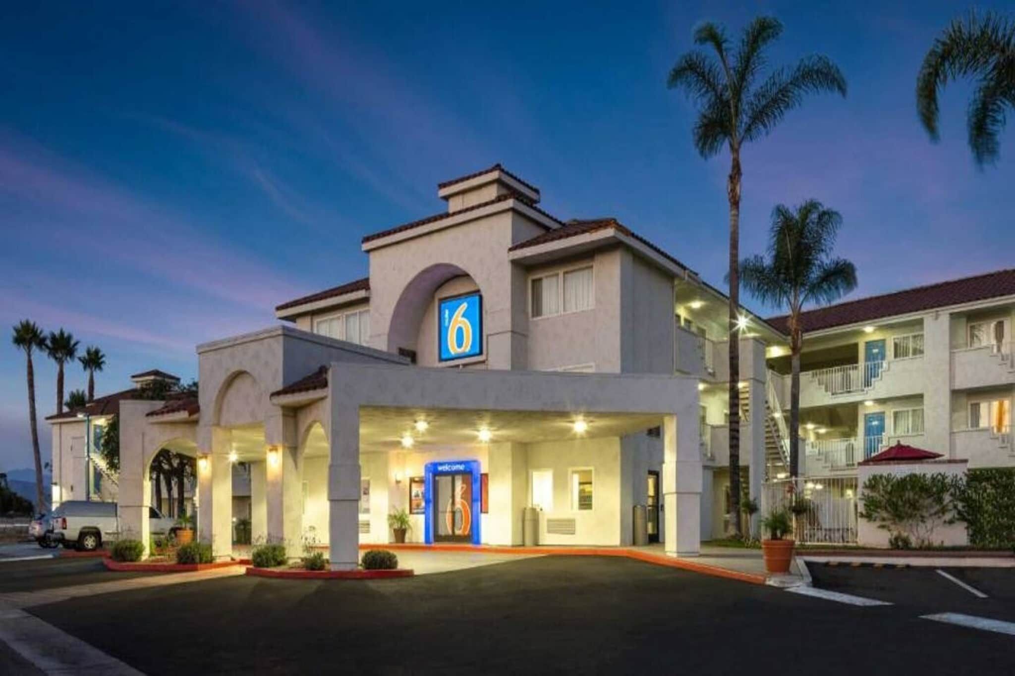 A hotel with a prominent '6' sign, a welcoming entrance, and a covered outdoor area.