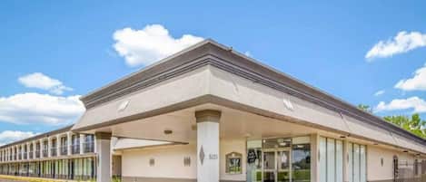 A building with a flat roof, large windows, and a covered entrance area.
