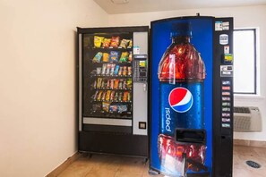 A vending machine with a Pepsi logo and a snack vending machine next to it. - 2 Full Beds | Smoking (Greensboro)