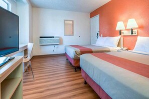 A hotel room with two beds, a desk, a television, and a wall-mounted air conditioner. - 2 Full Beds | Mini Fridge (Rowland Heights)