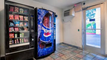 A vending machine with a Pepsi logo and a selection of snacks.