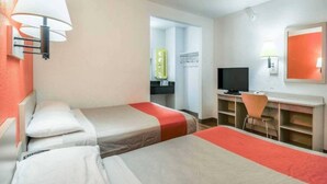 A hotel room with two beds, a desk, a television, and a chair. - 2 Full Beds | Mini Fridge (Chino)