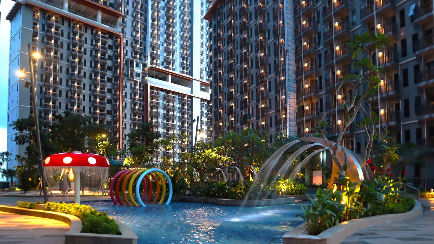 A modern residential building with multiple balconies, a central water feature, and a distinctive mushroom-shaped structure.