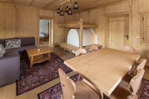 Un interno in legno con un divano, un tavolo e un'area pranzo.