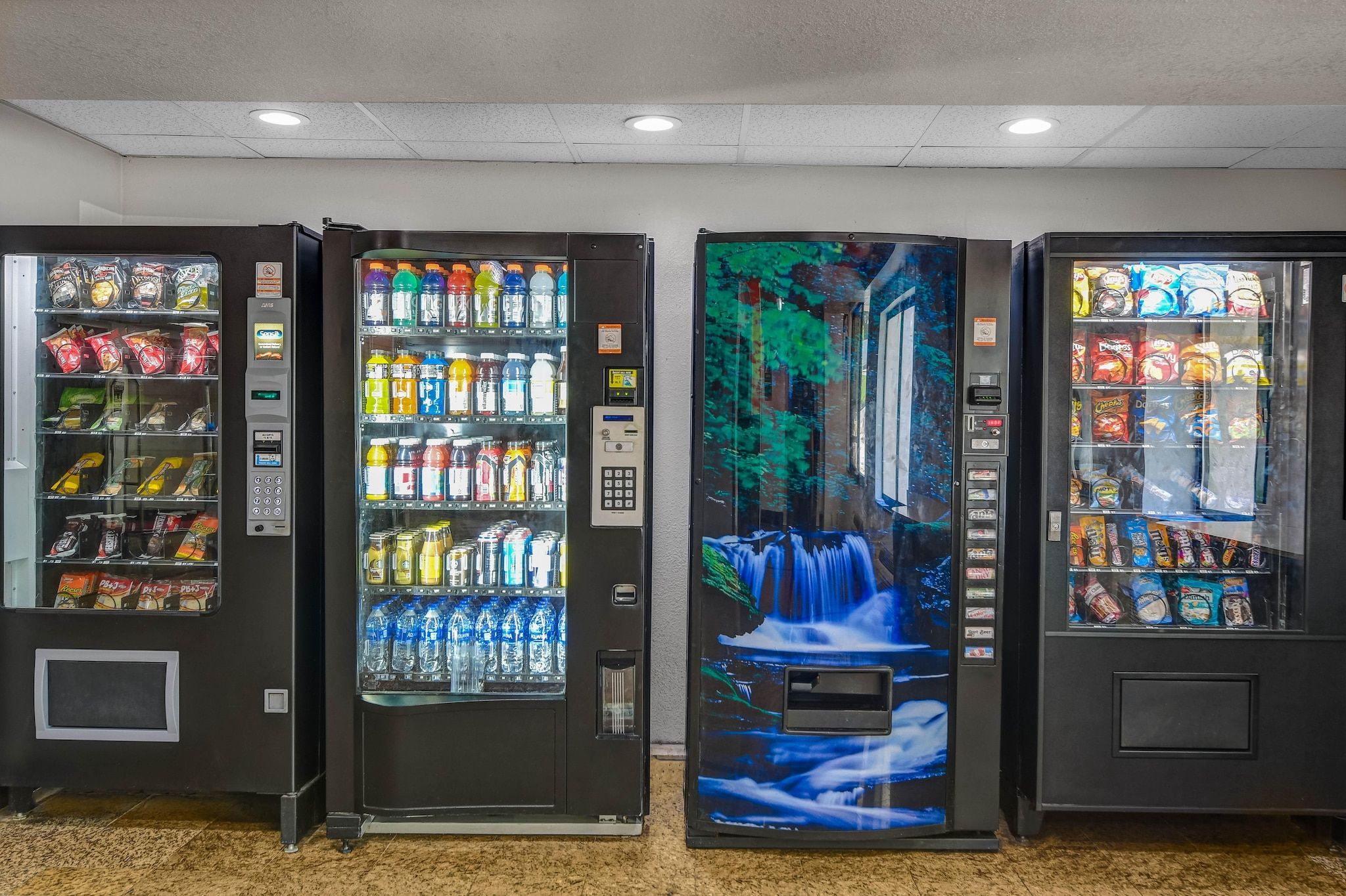 Three vending machines with various snacks and drinks.