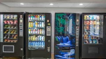 Three vending machines with various snacks and drinks.