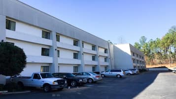 A multi-story hotel with a parking lot.