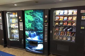 Three vending machines with various beverages and snacks. - 1 King Bed|Non-Smoking,Hot Tub (Norcross)