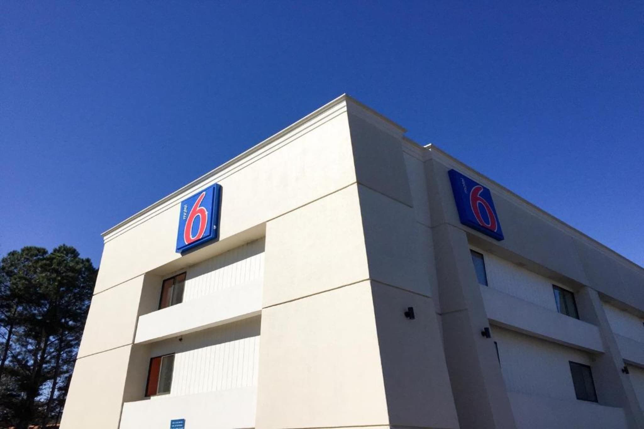 A building with a prominent '6' sign on the facade, indicating a hotel or similar establishment.