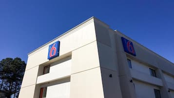 A building with a prominent '6' sign on the facade, indicating a hotel or similar establishment.