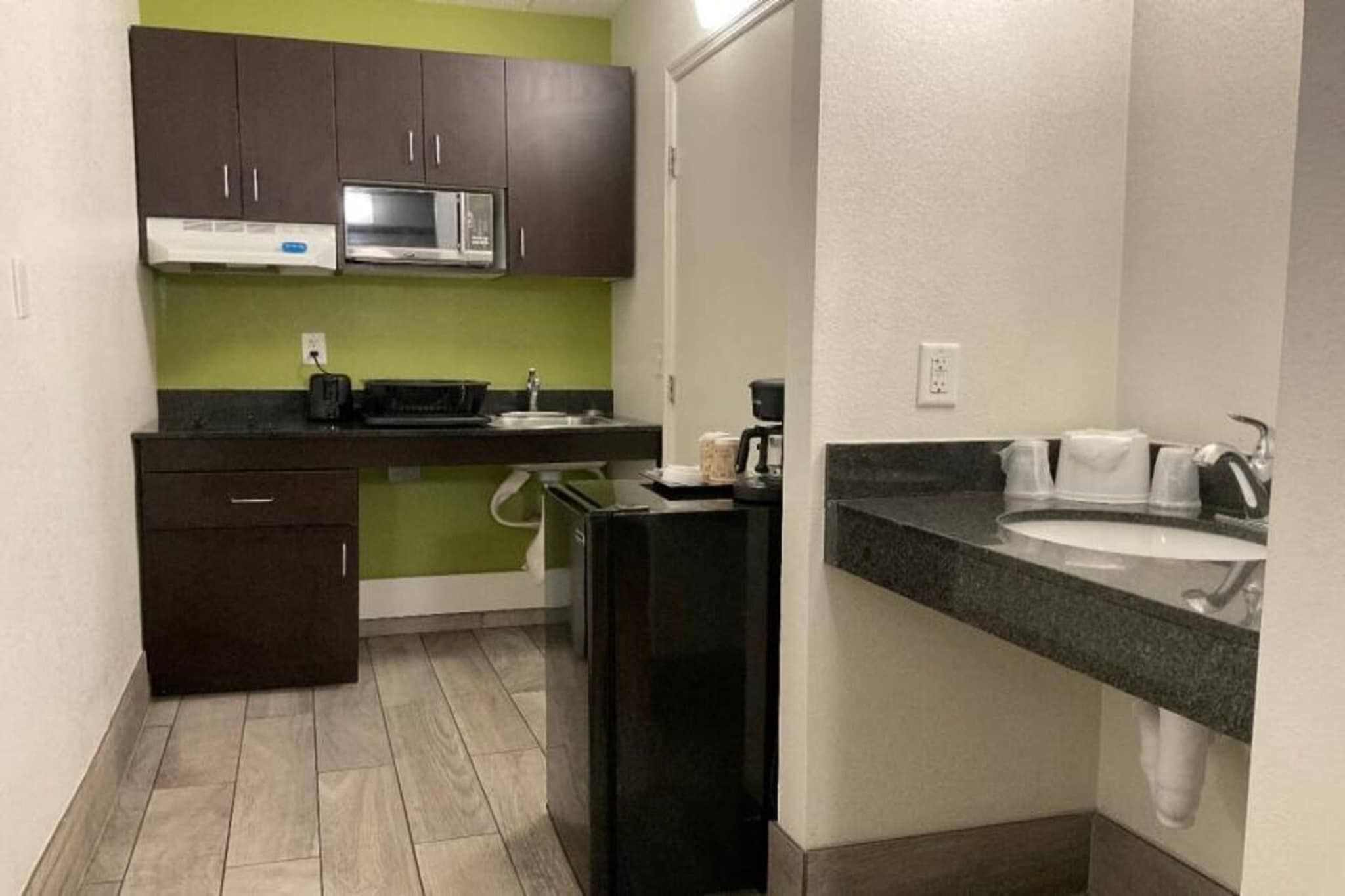 A compact kitchen with a microwave, toaster, and coffee maker.