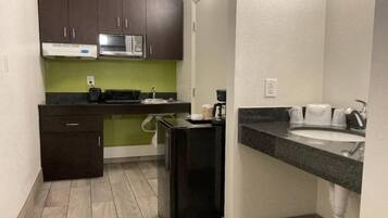 A compact kitchen with a microwave, toaster, and coffee maker.
