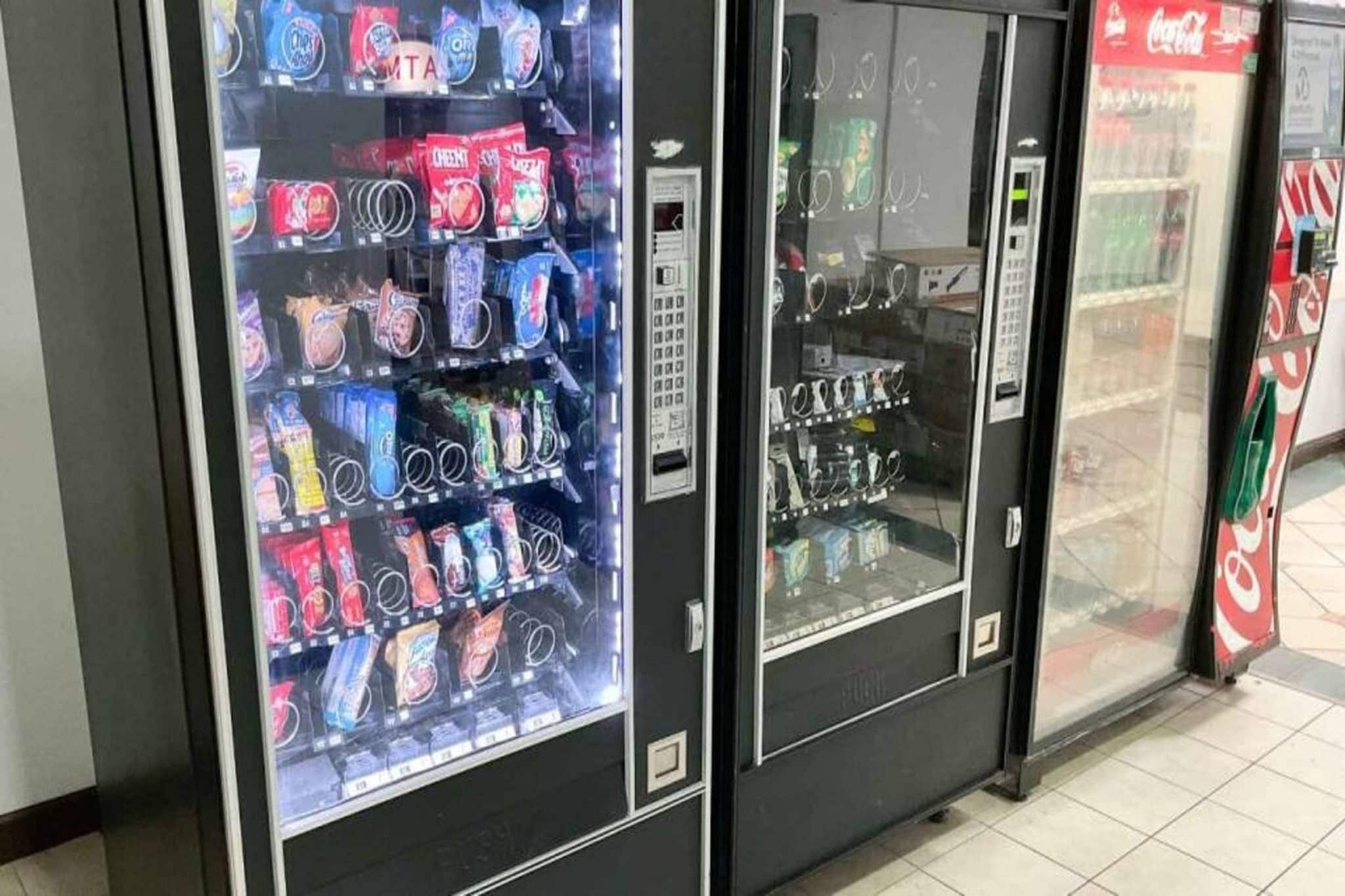 A row of vending machines with various snacks and drinks.