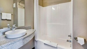 A bathroom with a sink, mirror, and shower. - 2 Full Beds | Non-Smoking, Micfridge (Norman)