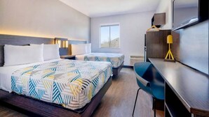 A hotel room with two beds, a desk, a chair, a TV, and a window. - 2 Full Beds | Non-Smoking, Micfridge (Norman)