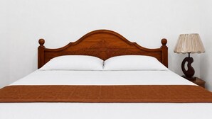 A bed with a wooden headboard, white pillows, and a brown blanket. - PiyaSewana Spice Garden Villa is located close to Colombo Katunayake Airport, (Banduragoda)