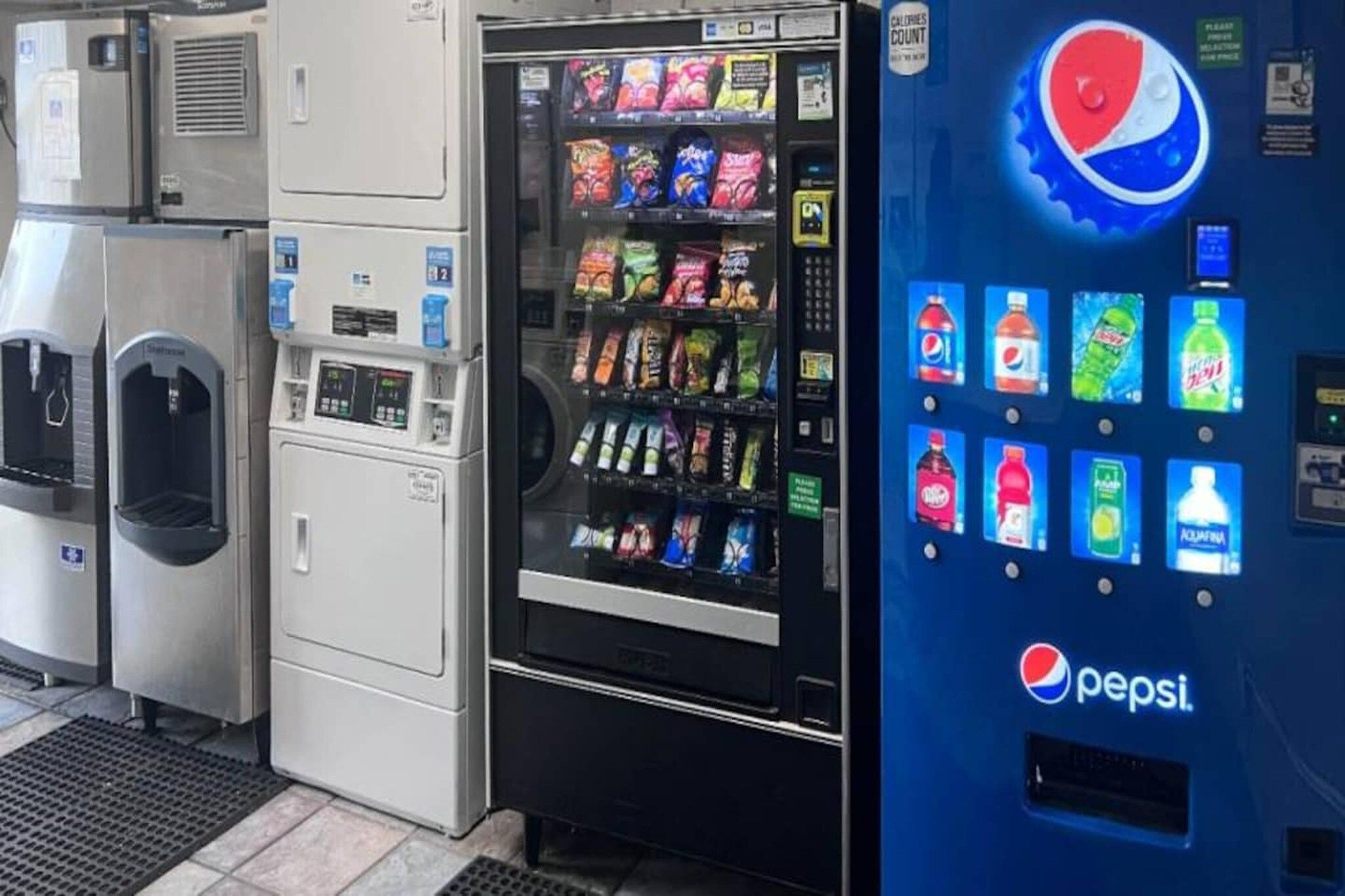 A vending machine with a Pepsi logo, a water dispenser, and a refrigerator.