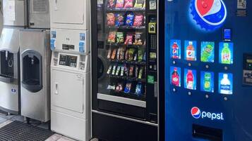 A vending machine with a Pepsi logo, a water dispenser, and a refrigerator.