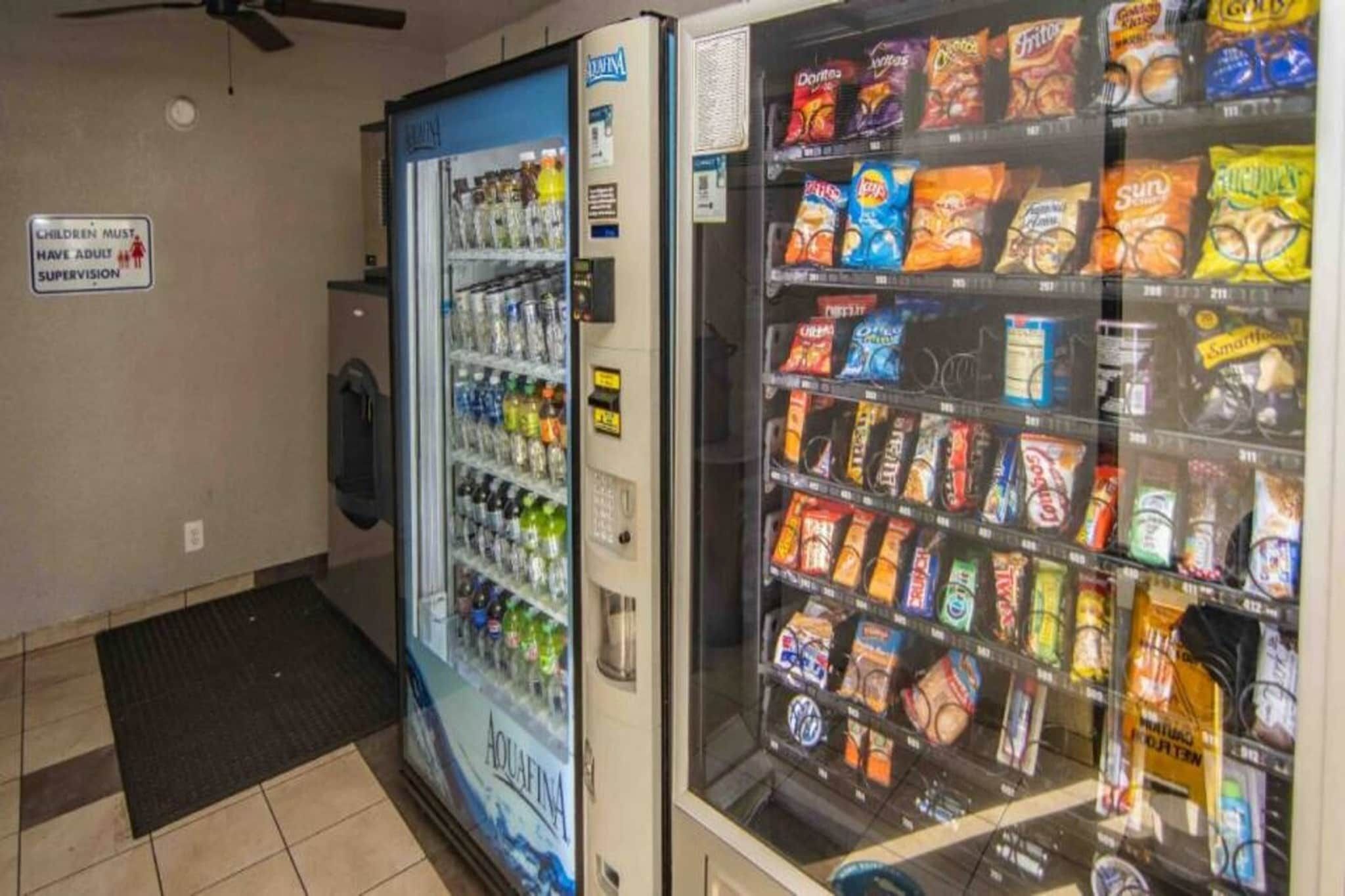 A vending machine area with a water cooler and snack vending machines.