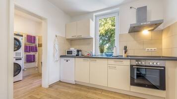 Eine moderne Küche mit Backofen, Mikrowelle und einem Fenster für natürliches Licht.