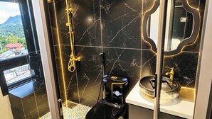 A modern bathroom with a shower, toilet, and sink. - D'Mont Boutique Hotel & Coffee (Sa Pa)