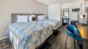 A hotel room with two beds, a desk, a chair, a mirror, and a nightstand. - 2 Queen Beds | Suite, Nsmk, Kitchen (Effingham)