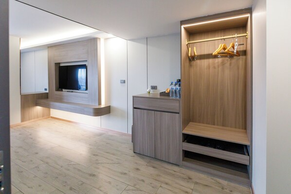 A modern bathroom with a built-in shower, a vanity with a mirror, and a towel rack.