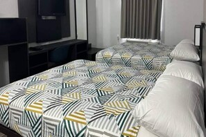 A hotel room with a bed, a television, and a desk. - 2 Full Beds | Non-Smoking (Omaha NE)
