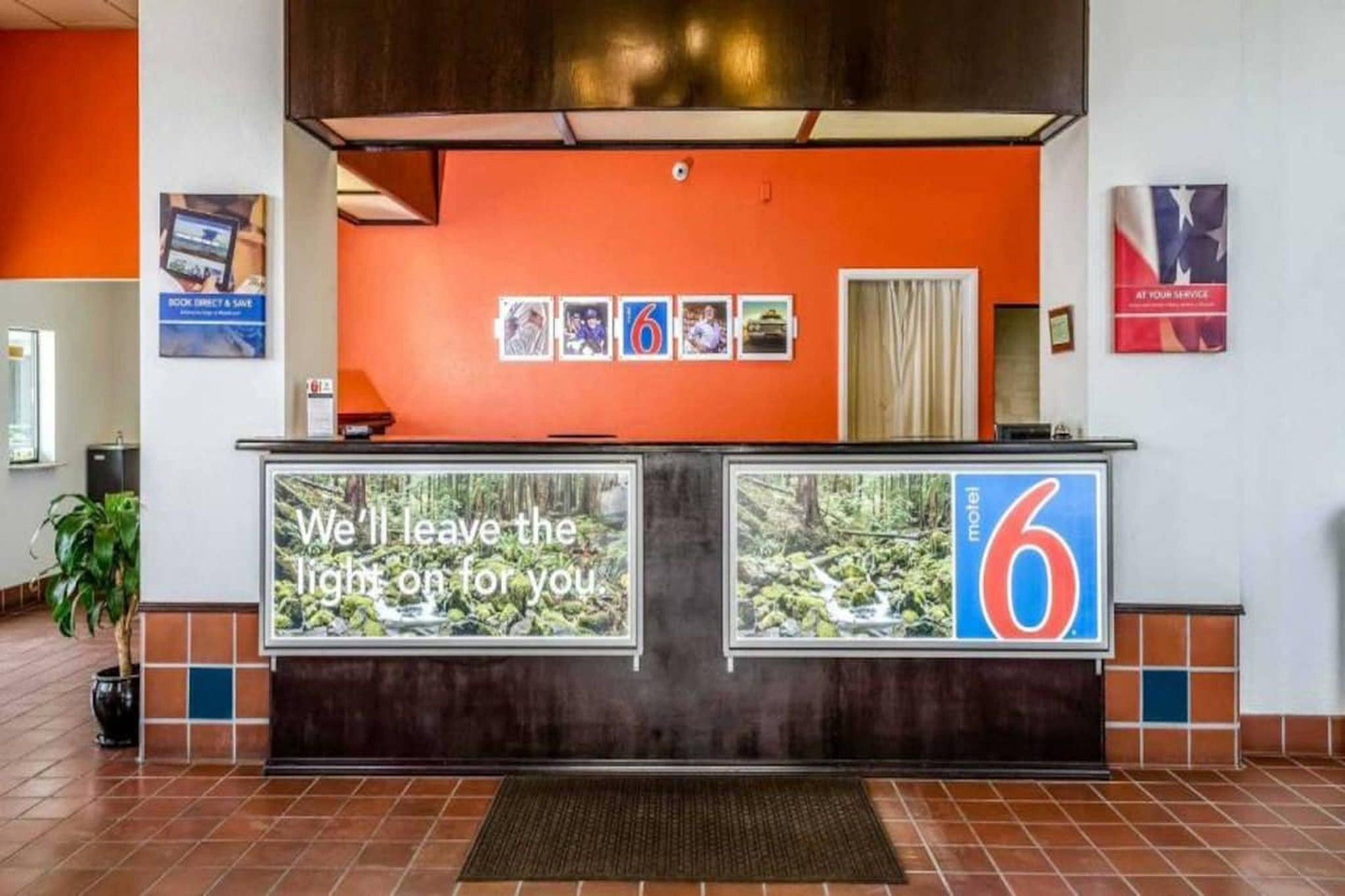 A reception desk with a large sign stating 'We'll leave the light on for you.'