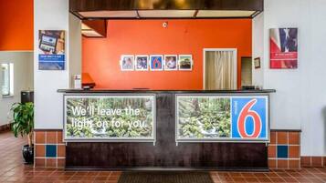 A reception desk with a large sign stating 'We'll leave the light on for you.'