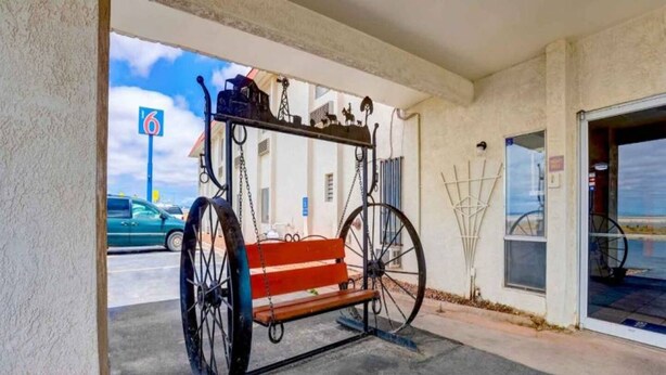 A vintage carriage parked outside a building with a clear sky in the background. - 2 Queen Beds | Non-Smoking, Micfridge (Moriarty)