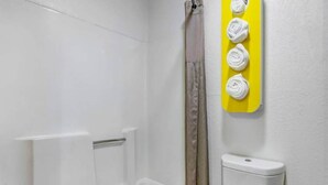 A bathroom with a white bathtub, a shower curtain, and a toilet. - 2 Queen Beds | Non-Smoking, Micfridge (Moriarty)