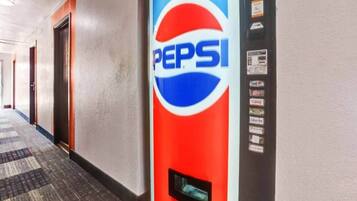 A hallway with a vending machine featuring the Pepsi logo.