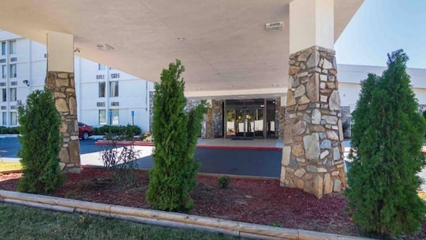 A building entrance with a covered walkway, stone pillars, and a parking lot. - 2 Queen Beds | Non-Smoking, Micfridge (Decatur GA)