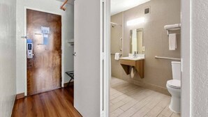 A hallway with a wooden door and a white wall. - 2 Queen Beds | Non-Smoking, Micfridge (Decatur GA)