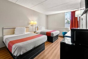 Een hotelkamer met twee bedden, een bureau, een stoel en een televisie.