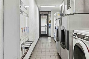A laundry facility with multiple washing machines and a bleacher area. - 2 Queen Beds | Non-Smoking, Kitchen (San Luis Obispo)