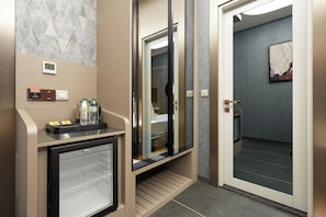 A hotel room with a minibar, a glass door leading to a bathroom, and a bed with a view. - PARK DEDEMAN KARTAL (Istanbul)